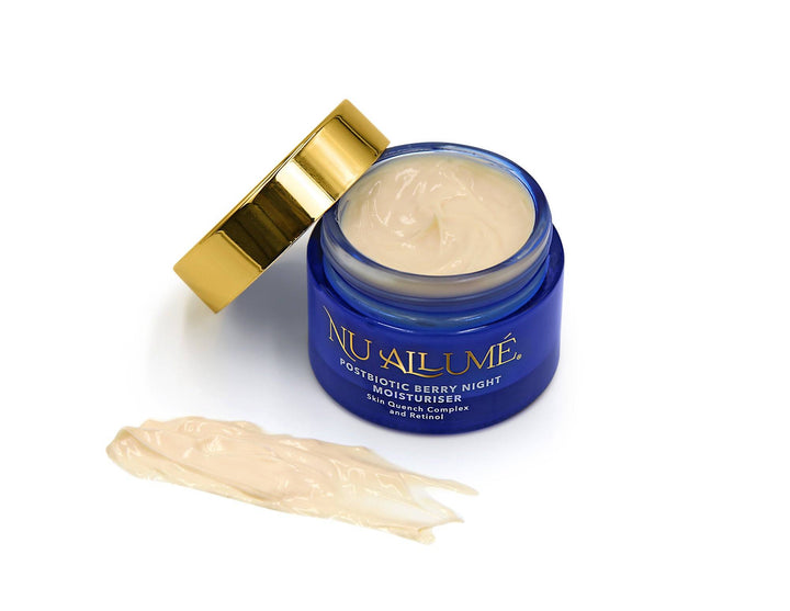 An open jar of Nu Allumé Postbiotic Berry Night Moisturiser with some of the moisturiser smeared on the surface to demonstrate its colour and texture